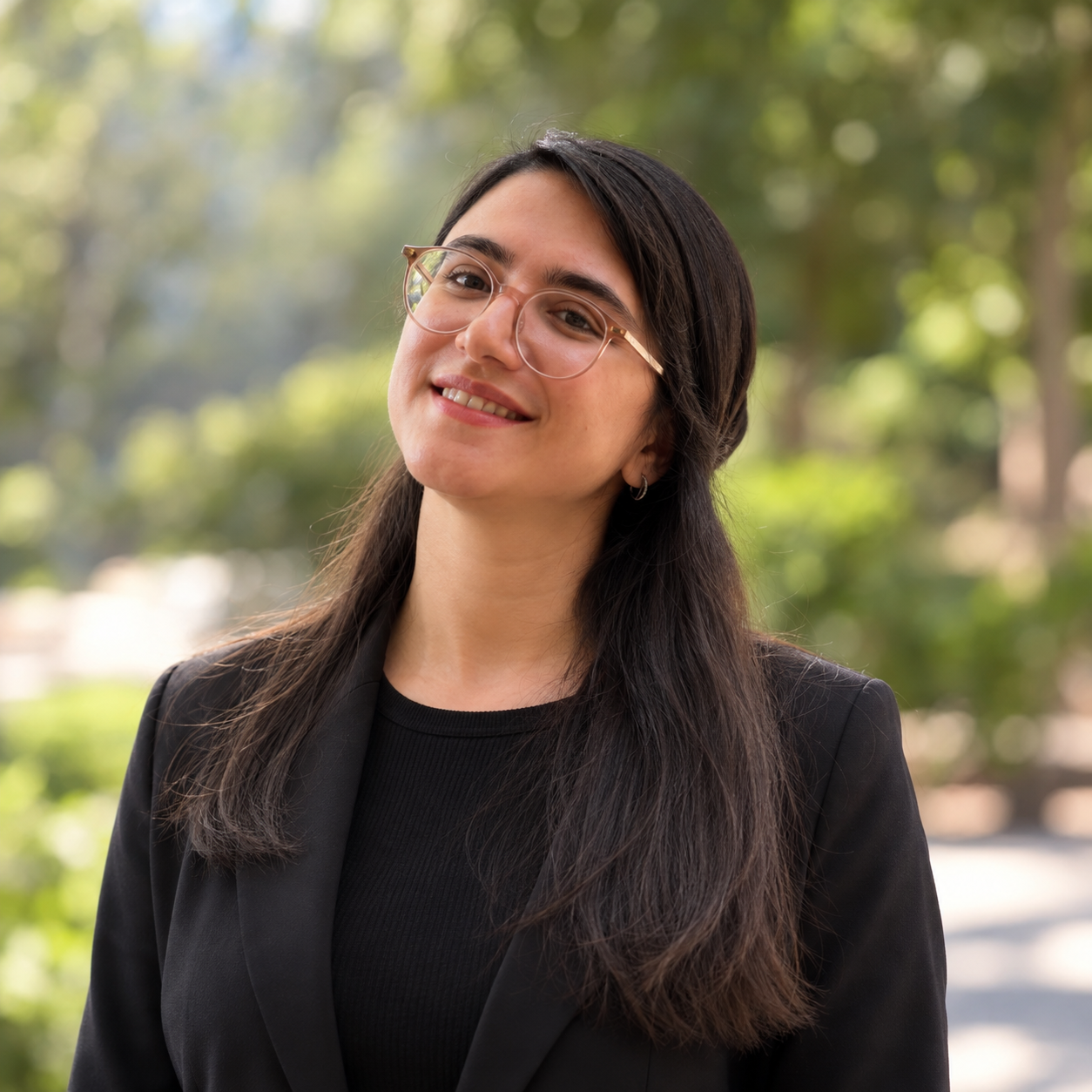 Nadia FallahTafti smiling outdoors in a professional portrait